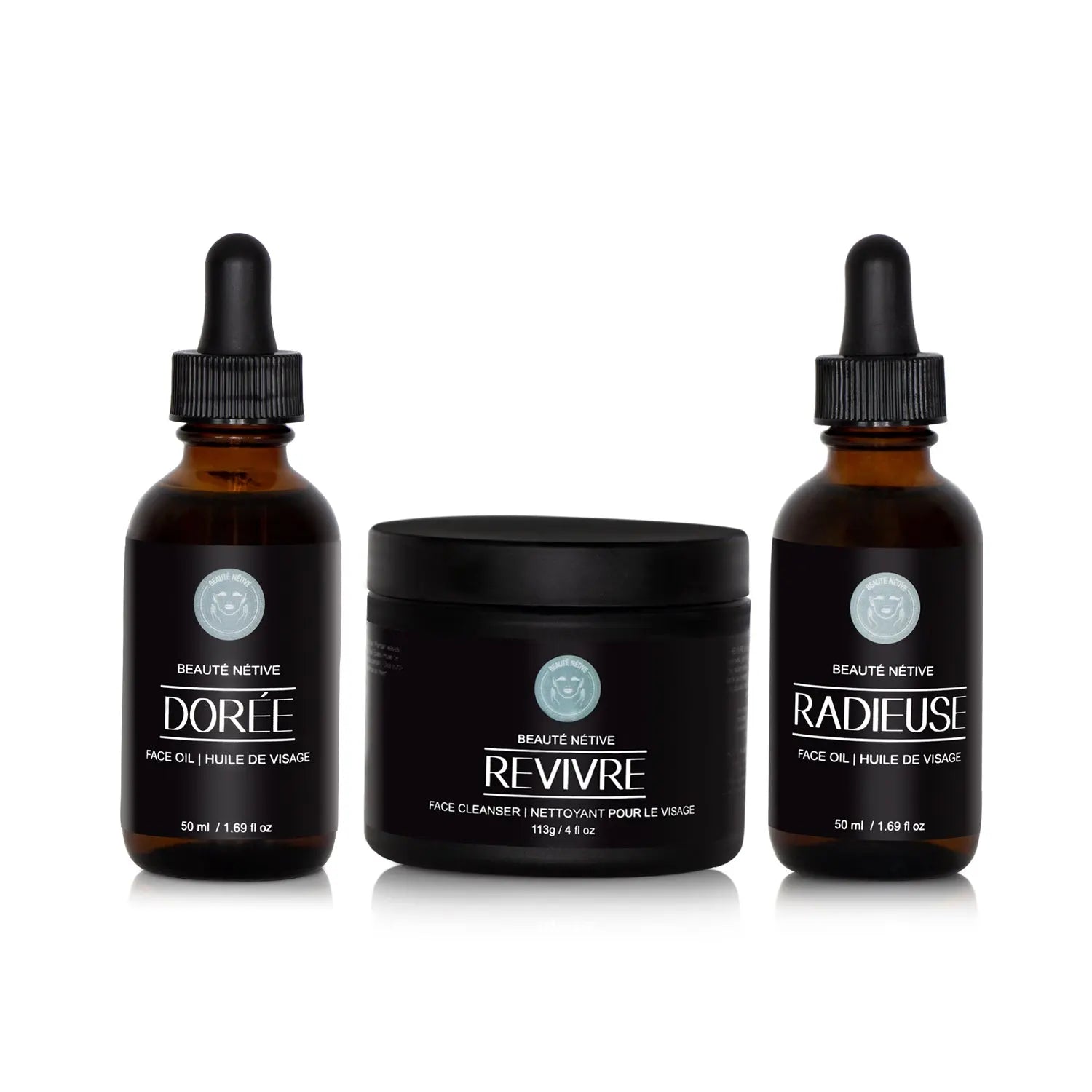 Beauté Nétive Skincare Transformation Trio featuring Dorée face oil, Revivre face cleanser, and Radieuse face oil in amber glass bottles with black labels and droppers, displayed on a white background.